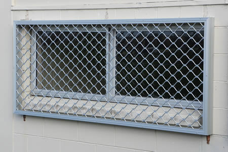 Security Screen fasterned to concrete blocks using buildout frame