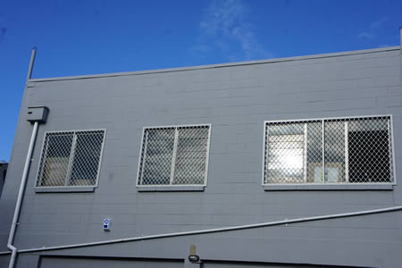 Security Screens on rear of retail store Hamilton Central